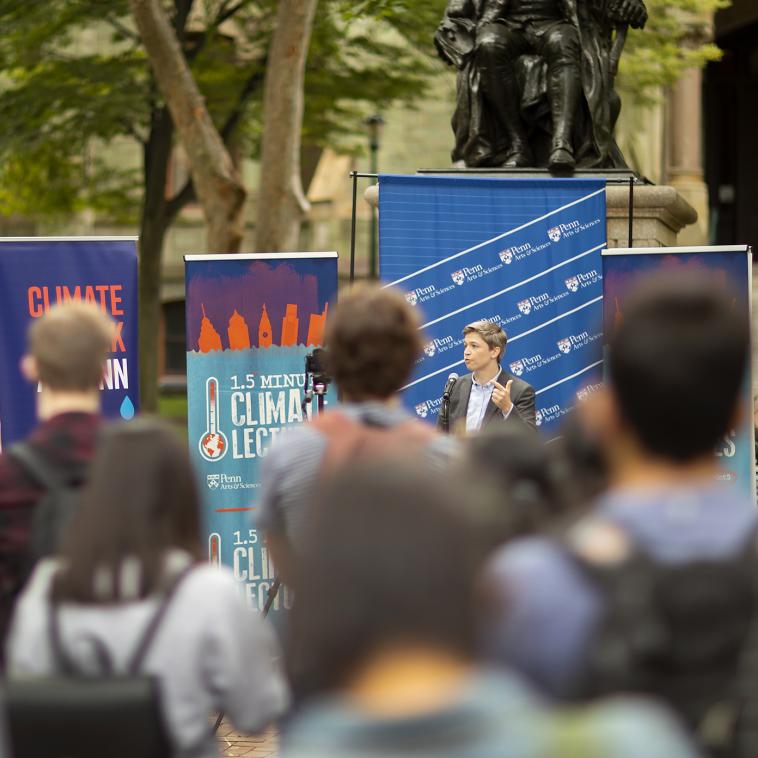 group on college green speaker with banners