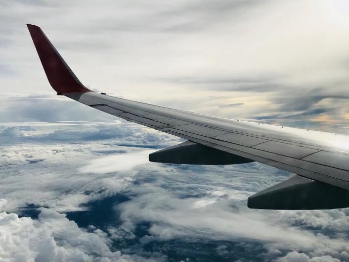 Airplane flying above clouds
