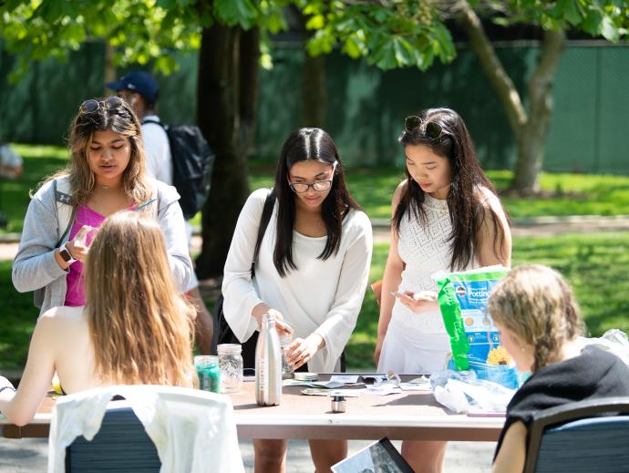 Students looking at table