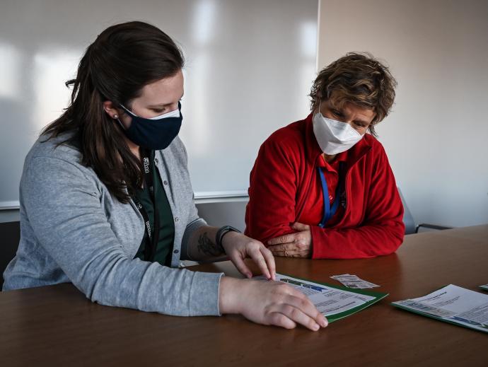 two women at table reviewing a document