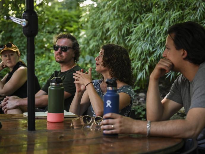 four people at table discussion group