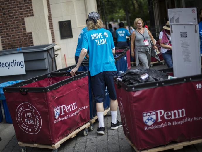 Folks assisting others with moving into a dormitory