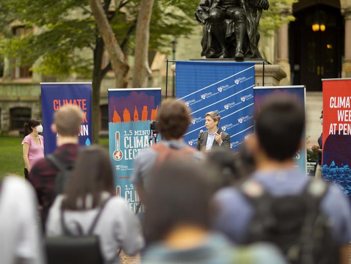 group on college green speaker with banners