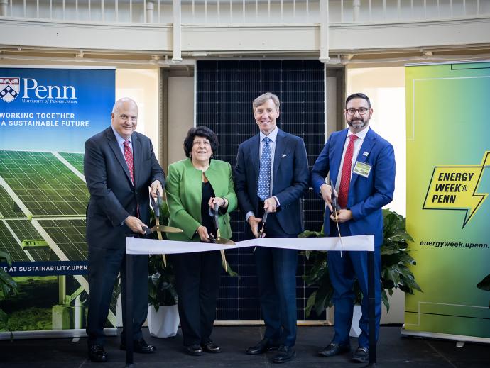 Four people cutting a ceremonial ribbon.