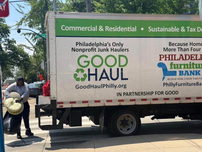 Philadelphia Furniture Bank employees load donations from Penn students into their truck.