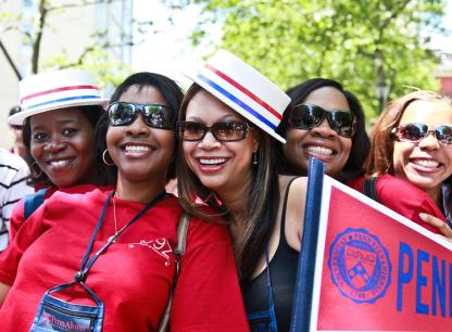 women with penn hats and flags