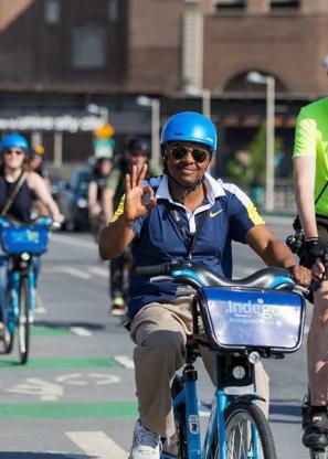 People biking to work with helmets on