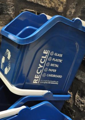 stacked blue recycling bins with handles